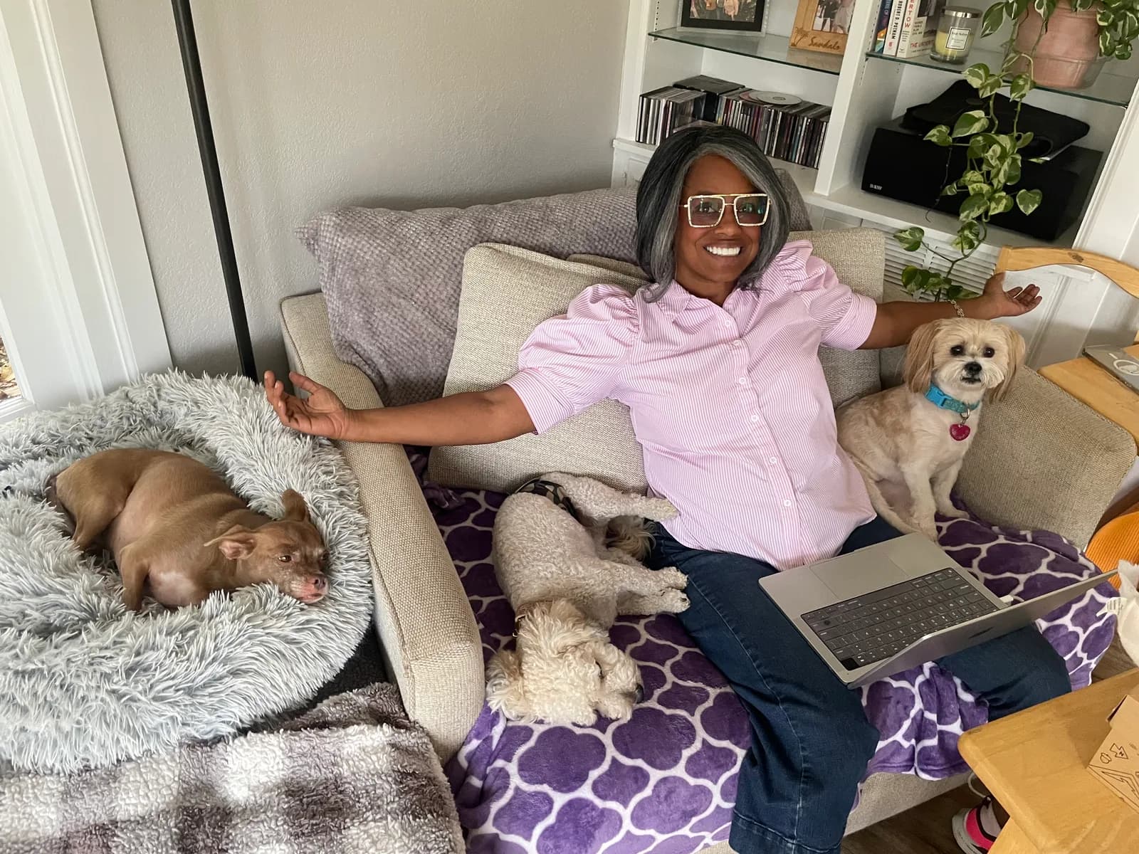 Jackye on the couch with three dogs during rest and cuddle time at Camp Clayton