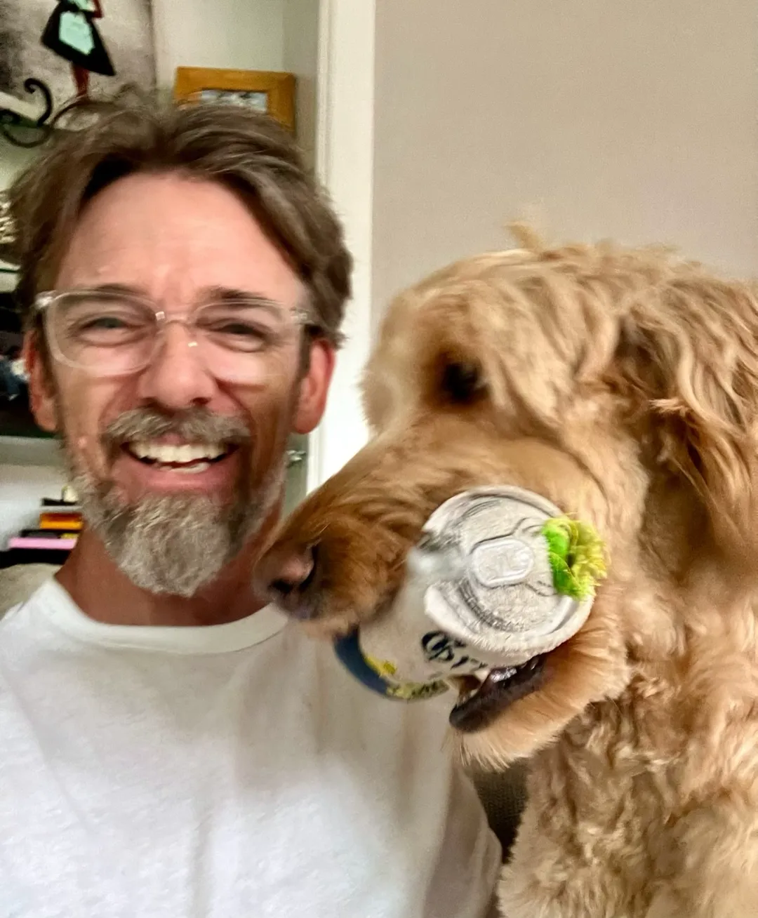 Todd Clayton, founder of Platinum Scoops, with a goldendoodle