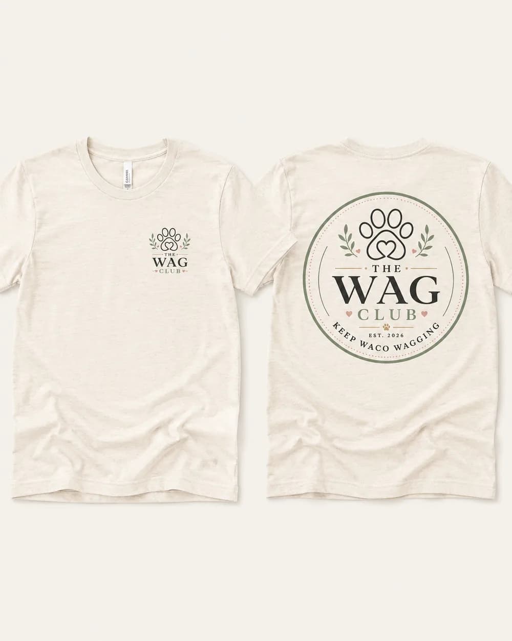 The Wag Club oatmeal t-shirt, front left-chest logo and full back emblem reading Keep Waco Wagging